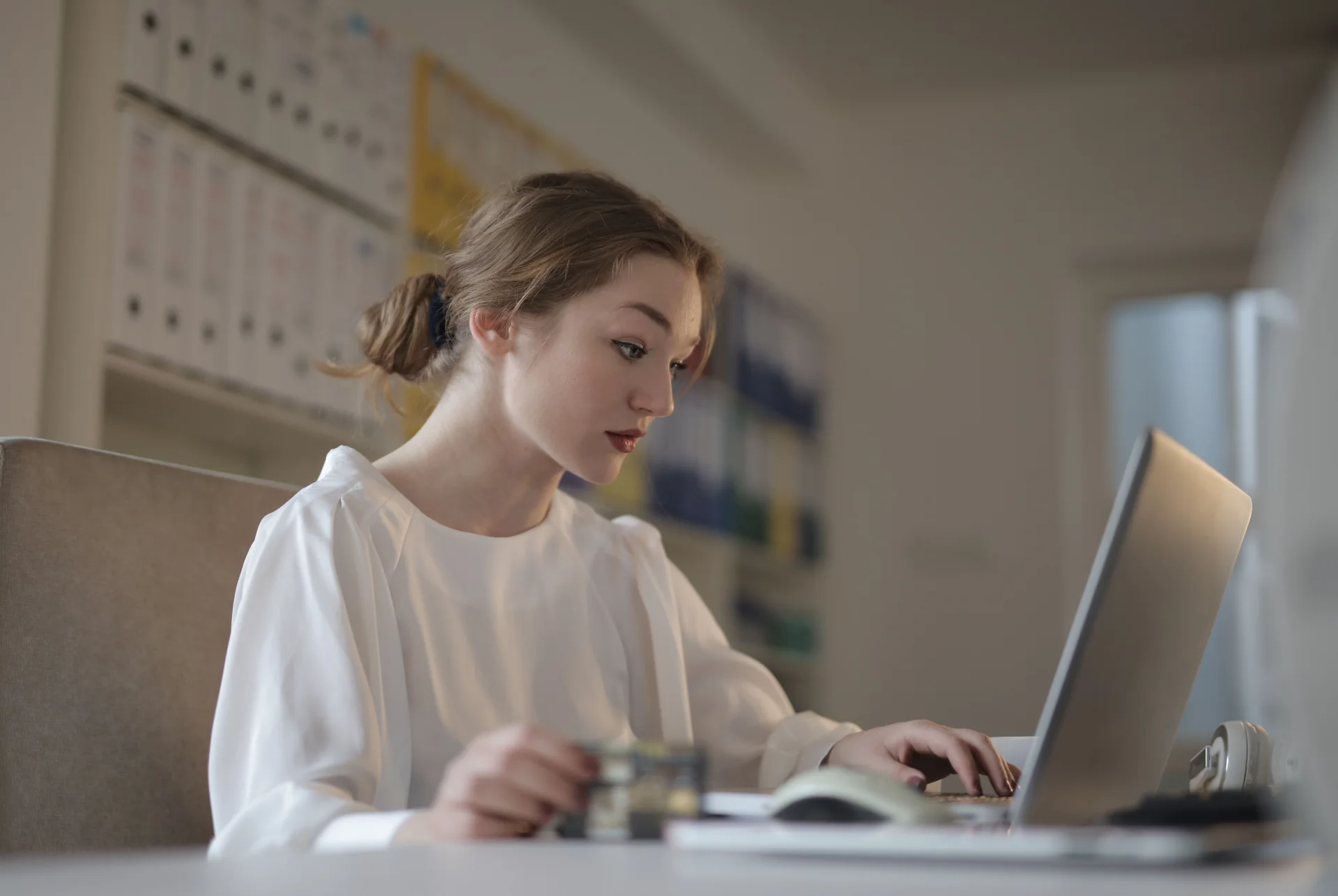 A young business professional working at her laptop